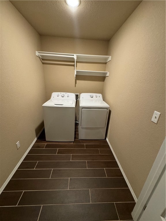 laundry room featuring a textured ceiling and washing machine and dryer