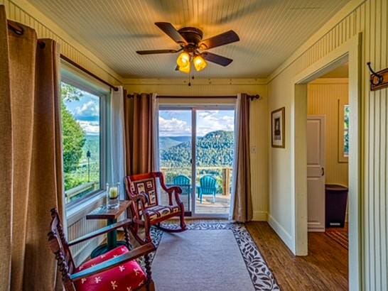 sitting room featuring ceiling fan and wood-type flooring