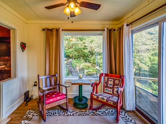 sitting room featuring hardwood / wood-style floors and ceiling fan