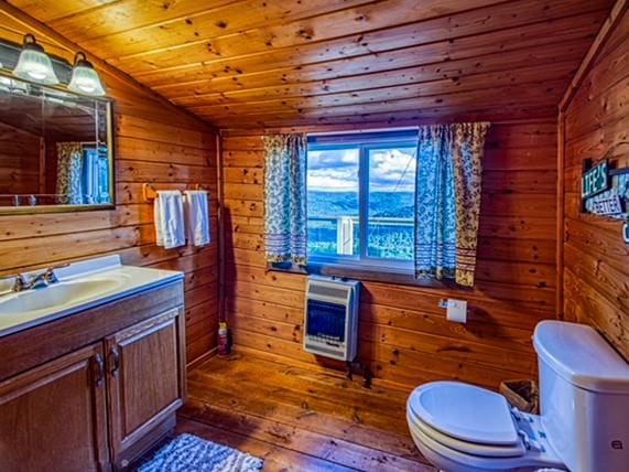 bathroom with wooden walls, wood ceiling, lofted ceiling, and wood-type flooring