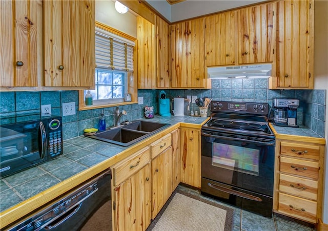 kitchen with decorative backsplash, sink, tile countertops, and black appliances