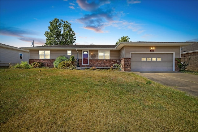 ranch-style house featuring a yard and a garage