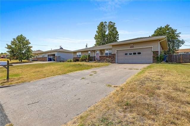 single story home with a front yard and a garage