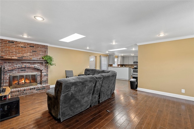 living room with a brick fireplace, a textured ceiling, crown molding, and dark hardwood / wood-style flooring