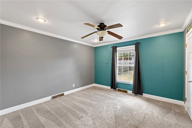 spare room featuring ceiling fan, ornamental molding, and carpet flooring