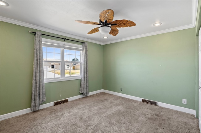 spare room with ornamental molding, carpet, and ceiling fan