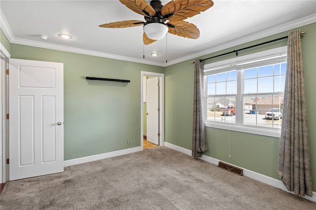 unfurnished bedroom with ceiling fan, light carpet, and ornamental molding