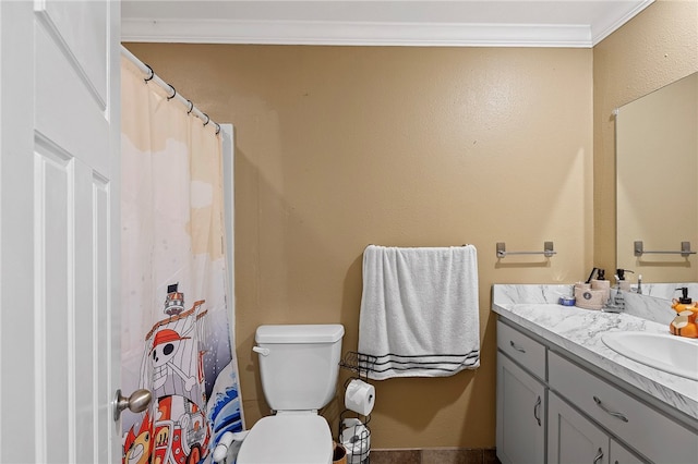 bathroom with ornamental molding, vanity, and toilet