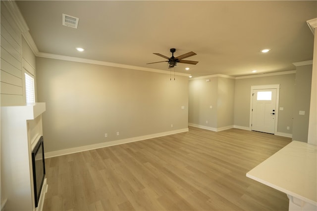 unfurnished living room with ceiling fan, crown molding, light hardwood / wood-style flooring, and a healthy amount of sunlight