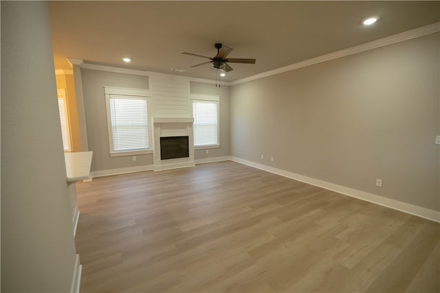 unfurnished living room with ornamental molding, ceiling fan, and light hardwood / wood-style flooring