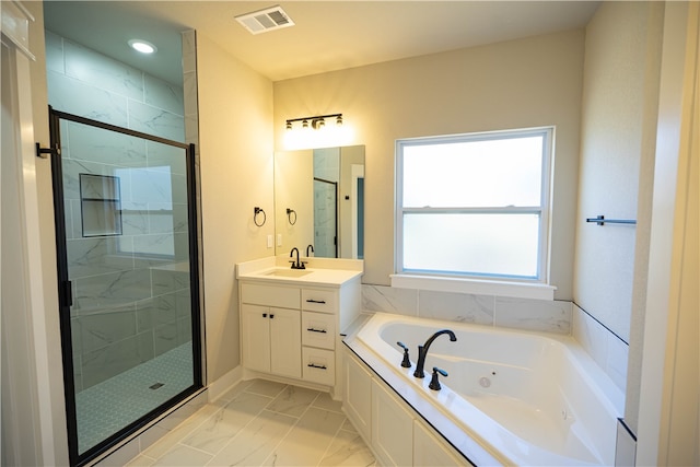 bathroom featuring separate shower and tub and vanity