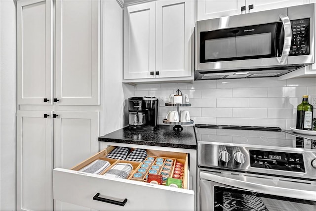 kitchen featuring white cabinetry, decorative backsplash, and appliances with stainless steel finishes