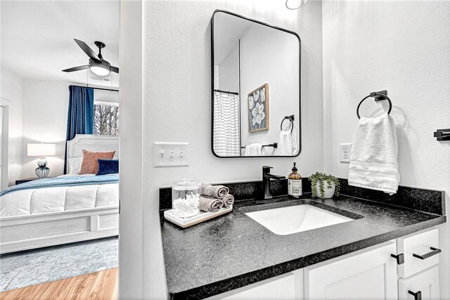 bathroom featuring vanity, hardwood / wood-style floors, and ceiling fan