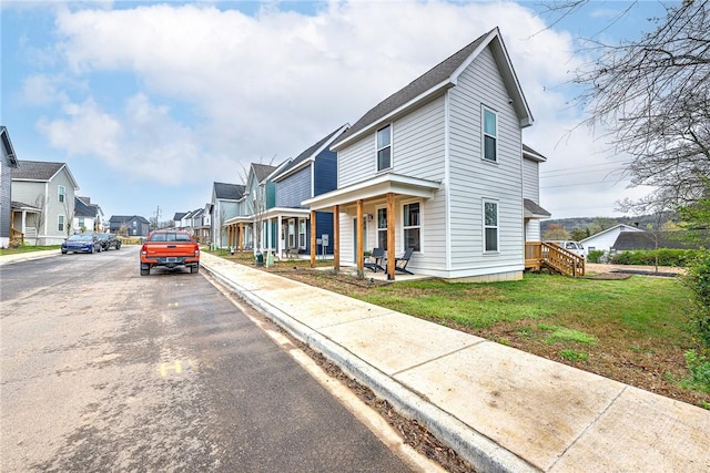 view of front of property featuring a front yard and a porch