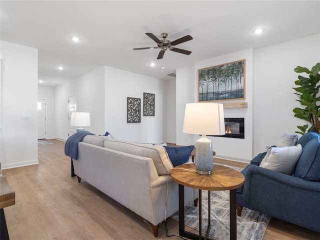 living room featuring ceiling fan and light hardwood / wood-style floors