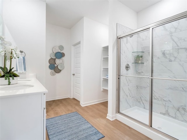 bathroom featuring an enclosed shower, vanity, and hardwood / wood-style flooring