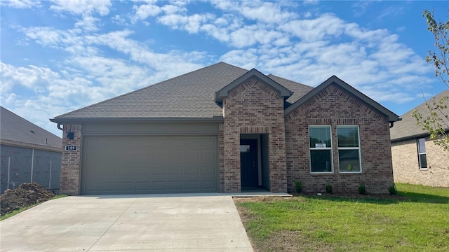 view of front of house with a front yard and a garage