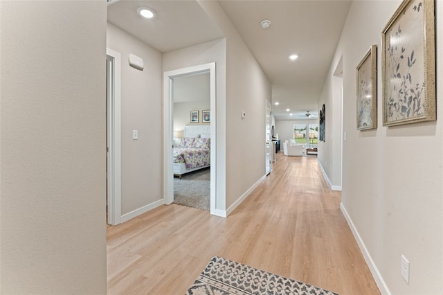 hallway with light hardwood / wood-style floors