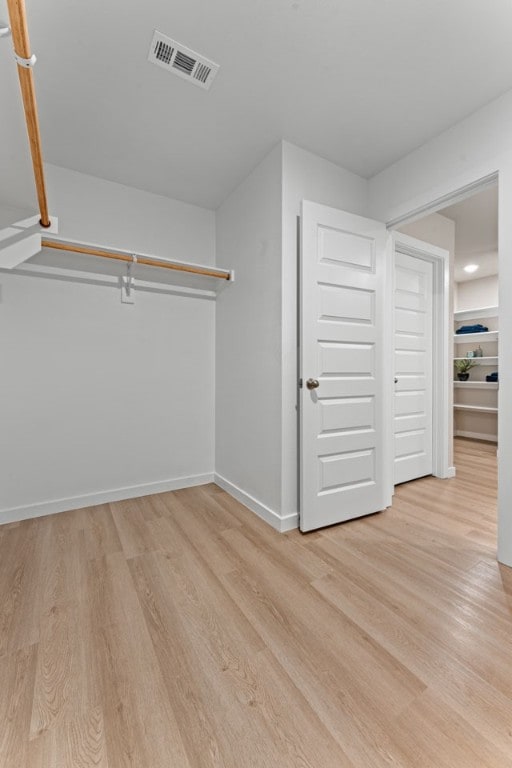 walk in closet featuring light hardwood / wood-style floors