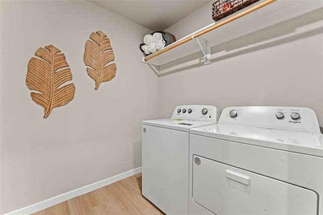 washroom featuring light wood-type flooring and washing machine and clothes dryer