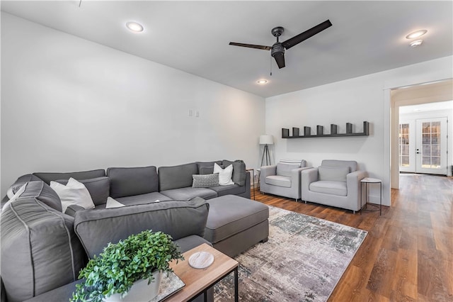 living room featuring dark hardwood / wood-style flooring and ceiling fan