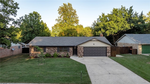 ranch-style house featuring a garage and a front lawn