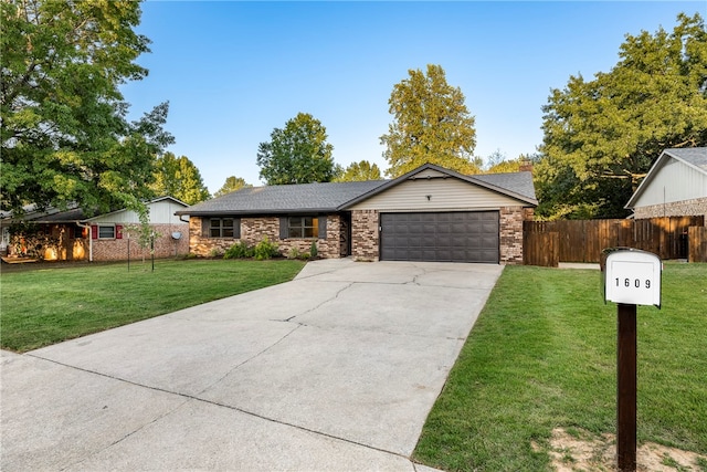 ranch-style home featuring a front yard and a garage