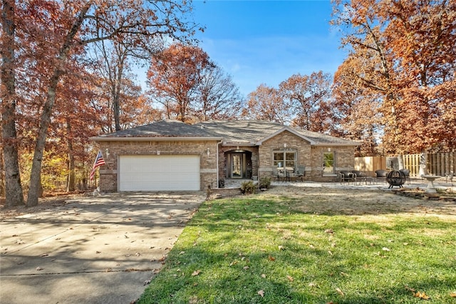 single story home with a garage and a front lawn