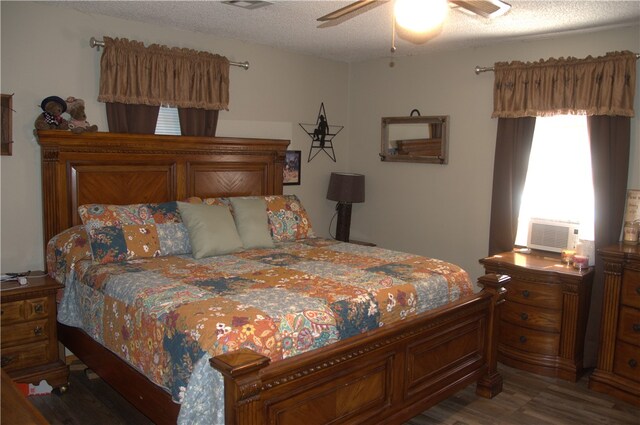 bedroom featuring a textured ceiling, dark hardwood / wood-style floors, and ceiling fan