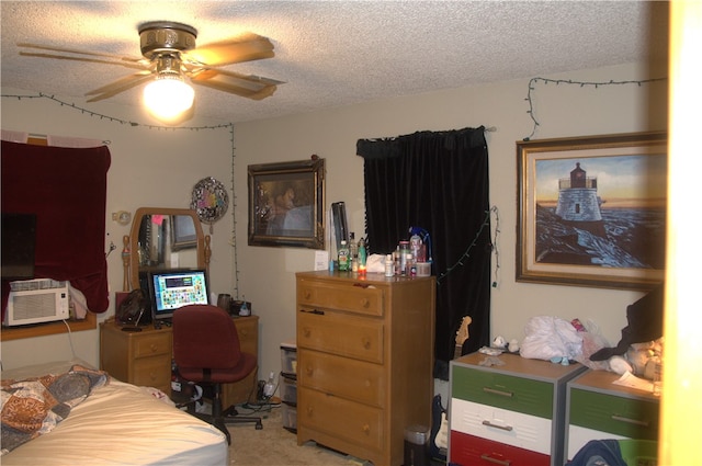 carpeted bedroom with a textured ceiling and ceiling fan