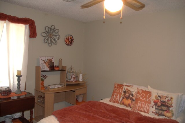 bedroom with a textured ceiling and ceiling fan