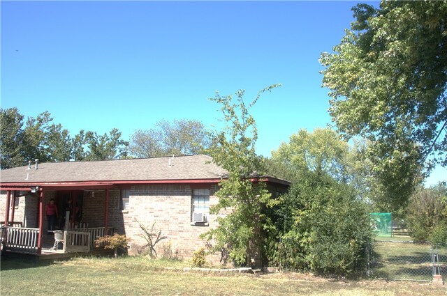 view of side of home with a yard