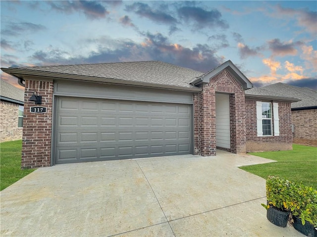 ranch-style home featuring brick siding, an attached garage, driveway, and a shingled roof