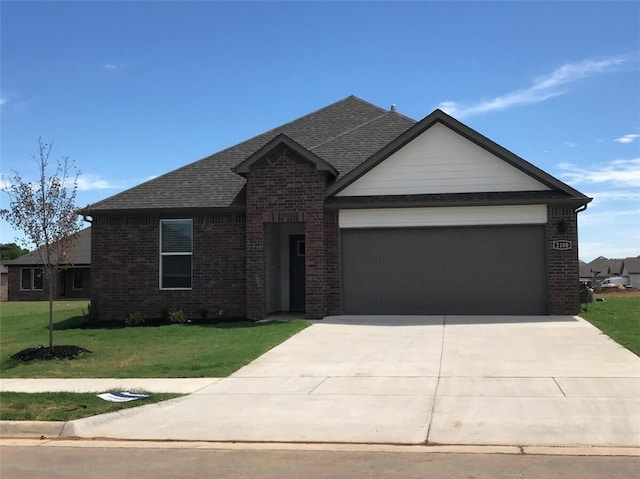 view of front of house with a front yard and a garage