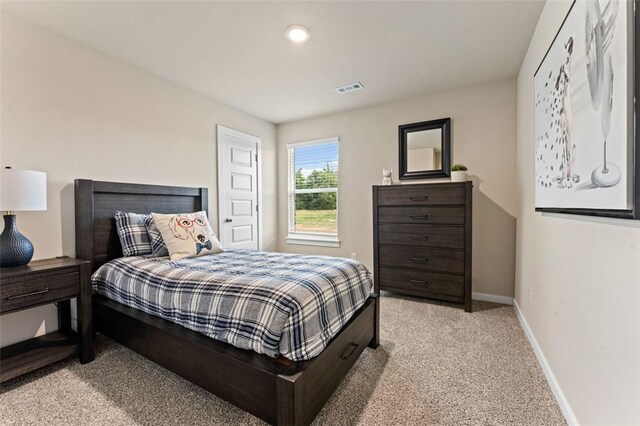 bedroom featuring light colored carpet