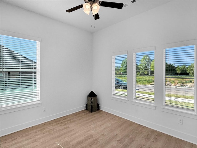 spare room featuring light hardwood / wood-style flooring and ceiling fan