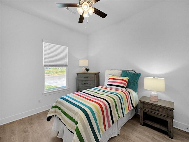 bedroom with light wood-type flooring and ceiling fan