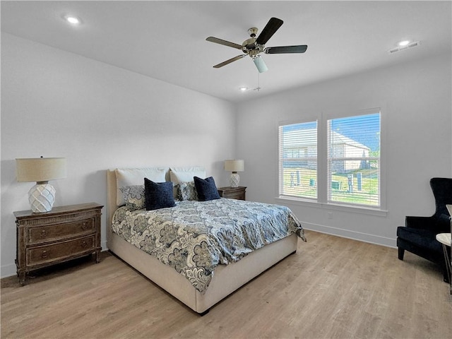 bedroom with ceiling fan and light hardwood / wood-style flooring