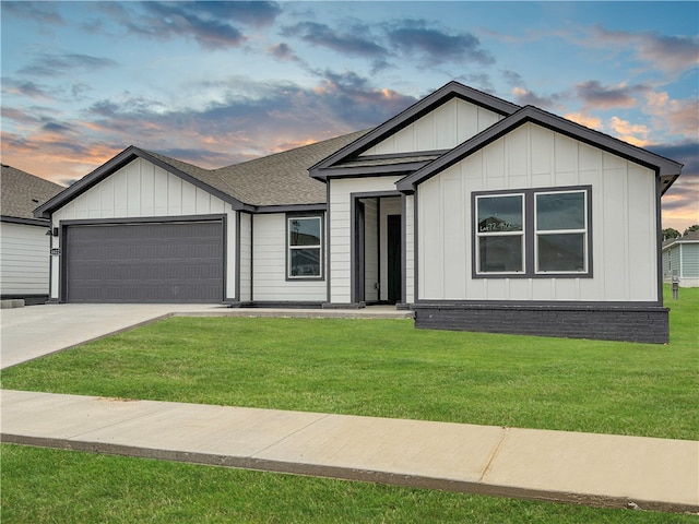 view of front of house with a garage and a lawn