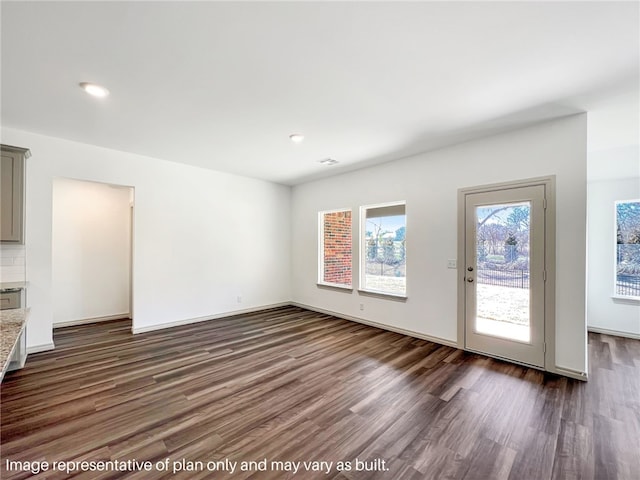 unfurnished living room with dark hardwood / wood-style floors