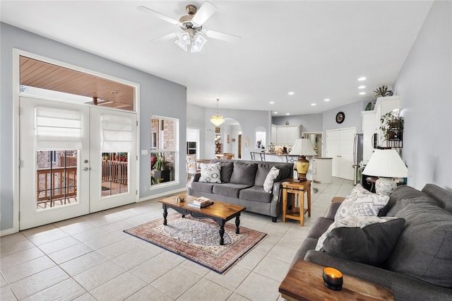 tiled living room with ceiling fan