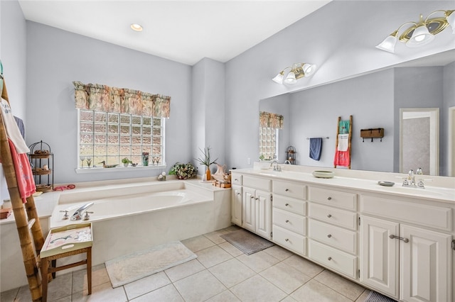 bathroom featuring tile patterned flooring, a bathing tub, and vanity