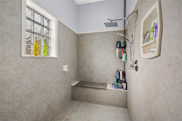 bathroom featuring tile patterned flooring and tiled shower