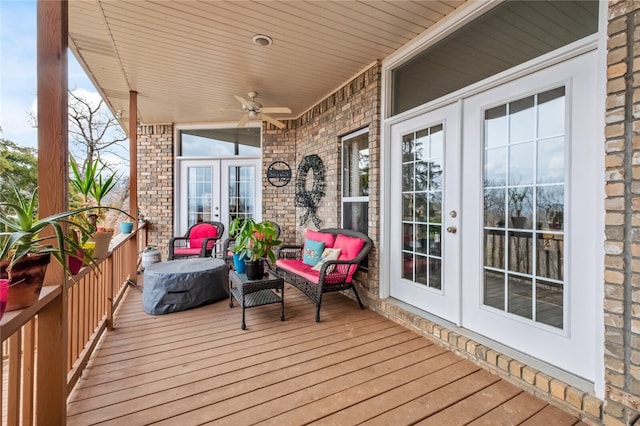 wooden terrace featuring ceiling fan and french doors