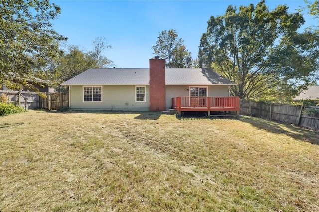 back of house featuring a yard and a deck