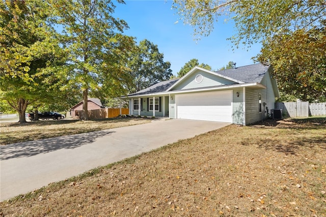 ranch-style house with a garage and central AC unit