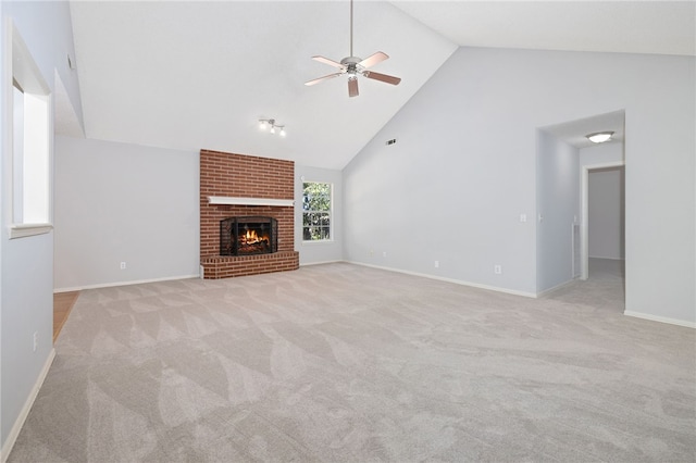 unfurnished living room with a fireplace, light colored carpet, high vaulted ceiling, and ceiling fan