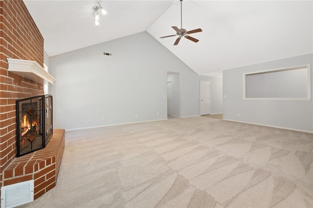 unfurnished living room with high vaulted ceiling, ceiling fan, a fireplace, and light carpet