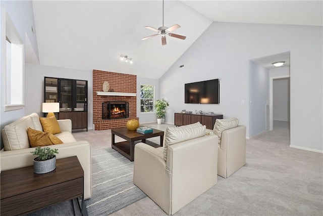 living room with a fireplace, light carpet, high vaulted ceiling, and ceiling fan