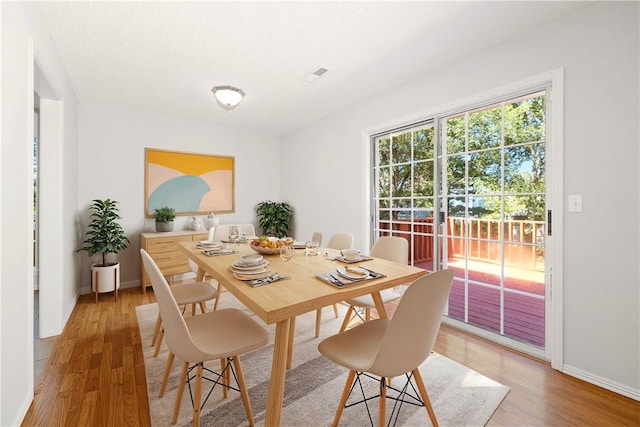 dining space with light wood-type flooring